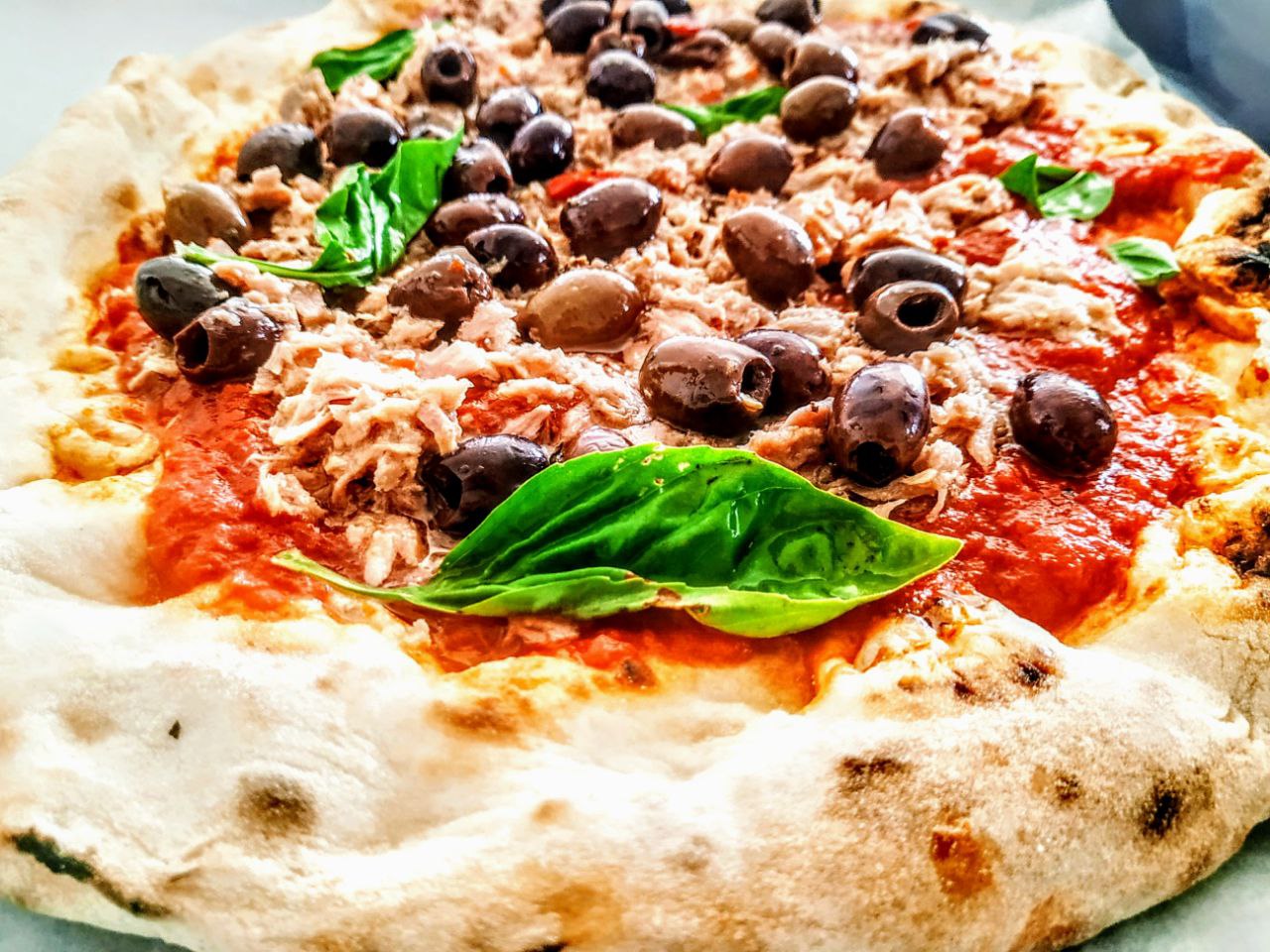 Ricette semplici economiche e gustose senza formaggio: pizza rossa con passata di pomodoro bio tonno olive nere e basilico